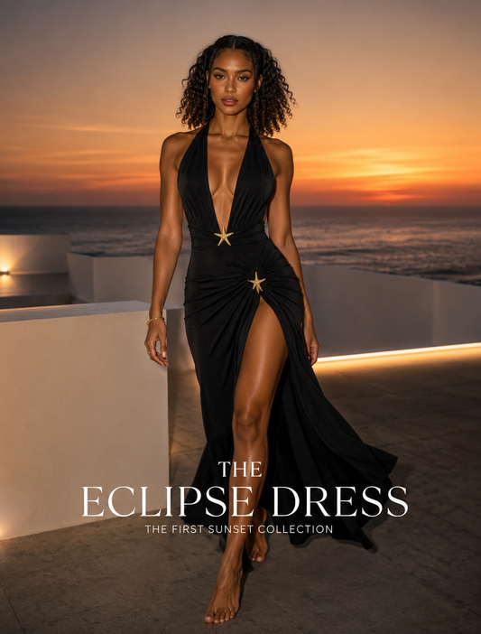 Model wearing the black floor-length Eclipse Dress at sunset, front view with plunging neckline